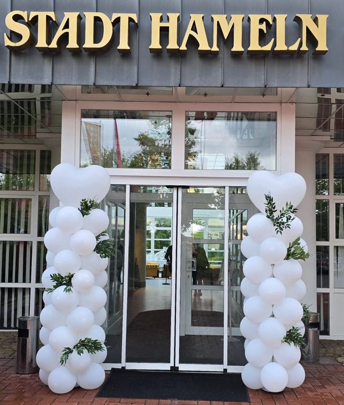 Ballondekoration Hameln · Weiße Ballonsäulen mit Herzen und Eukalyptus am Eingang vom Hotel Stadt Hameln